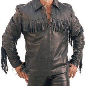 May include: Black leather shirt with fringe detailing across the chest and sleeves. The shirt features a lace-up front and a collared neckline. The sleeves have fringe accents. The shirt is paired with black leather pants.