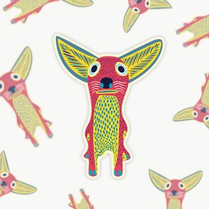 May include: A whimsical sticker featuring a stylized creature with large, yellow-lined ears and a red body. The creature has a blue nose and yellow and blue patterned chest. Additional stickers of the same design are scattered across a white background.