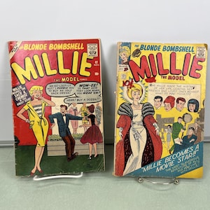 Puede incluir: Dos cómics vintage con un personaje femenino llamado Millie. Las portadas son rojas y amarillas con el título "The Blonde Bombshell Millie The Model". El primer cómic presenta a Millie con un vestido amarillo y el segundo cómic presenta a Millie con un vestido blanco y una estola de piel.