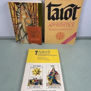 May include: Three tarot books are displayed. The top right book is titled "Tarot: A New Handbook for the Apprentice" by Eileen Connolly. The top left book is "Understanding Allister Crowley's Thoth Tarot". The bottom book is "Tarot Cards for Fun and Fortune Telling".