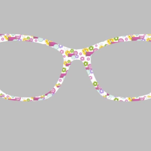 May include: Cat-eye style eyeglasses with a white frame decorated with a colorful floral pattern. The pattern includes pink, yellow, and green flowers and other shapes. The glasses are set against a gray background.