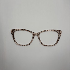 May include: A pair of cat-eye glasses with a leopard print frame.