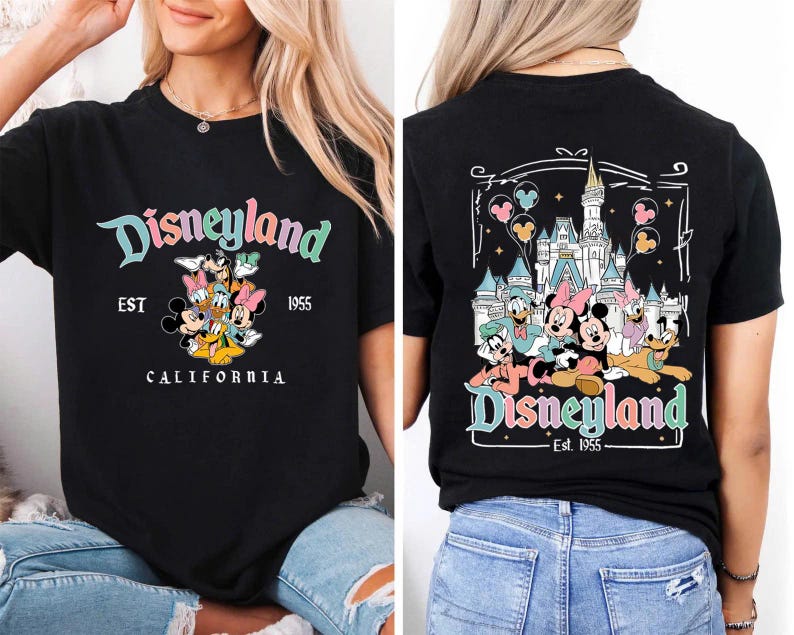 May include: Black t-shirt featuring the Disneyland logo in teal, pink, and yellow, with a group of cartoon characters. The front of the shirt says "Disneyland EST 1955 CALIFORNIA". The back of the shirt features a castle and more characters.