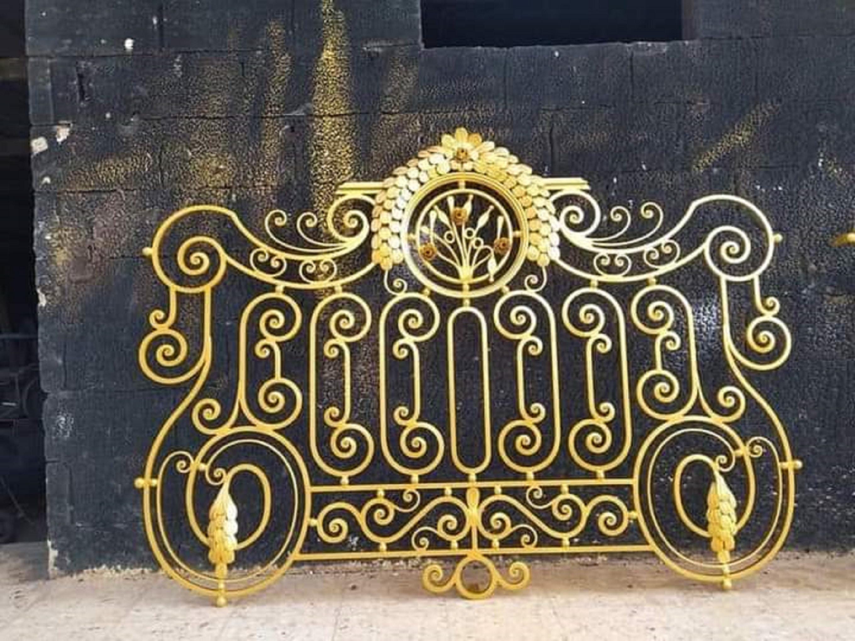 Handmade wrought iron railing with gold floral medallion cres