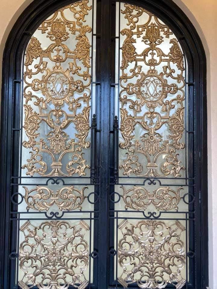 Handmade arched wrought iron double door with gold accent overlay and glass panels, Lahore Pakistan
