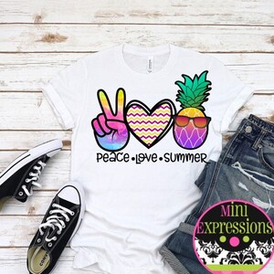 May include: White t-shirt with a peace sign, heart, and pineapple graphic. The text "Peace Love Summer" is printed below the graphic.