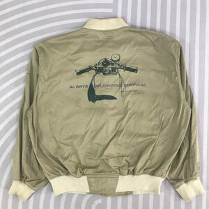 May include: A white ceramic mug with a black handle and the text "But First, Coffee" in a bold, black font. The mug is set against a neutral background, highlighting its simple design.