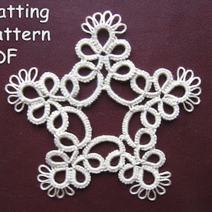 May include: A white crocheted star-shaped tatting pattern. The pattern is on a dark red background. The text "Tatting pattern PDF" is visible in the top left corner of the image.