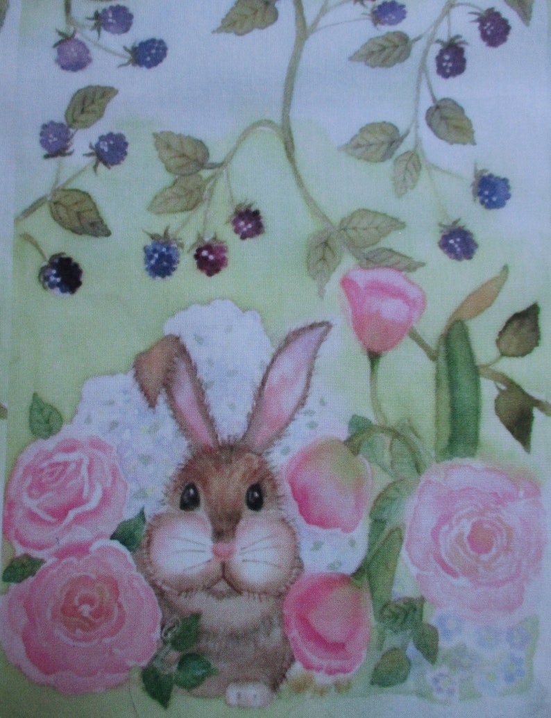 May include: A watercolor painting of a brown bunny surrounded by pink roses and peaches. The bunny has long ears and a fluffy face. Dark purple blackberries and green leaves are scattered throughout the background.
