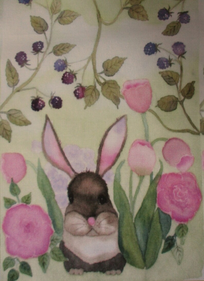 May include: Watercolor painting of a brown and white bunny with pink-lined ears, nestled among pink roses, tulips, and green foliage. Dark purple berries hang from vines in the background, set against a light green backdrop.