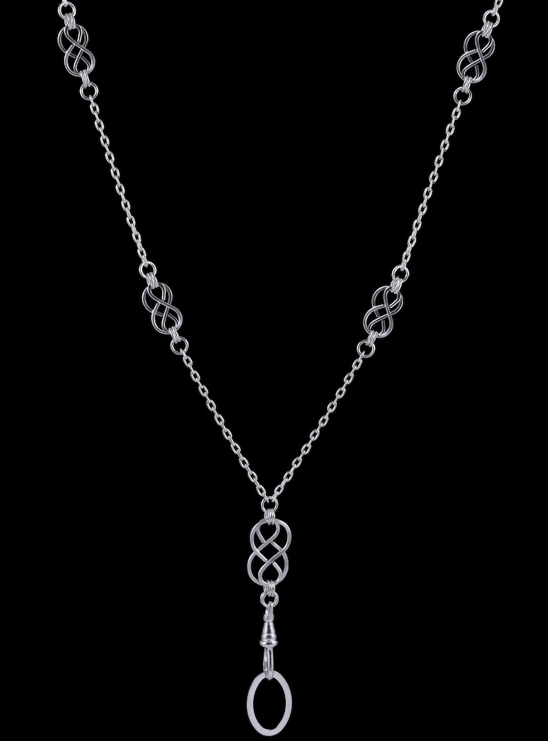 May include: A silver chain necklace with a silver infinity symbol pendant and a silver ring at the end. The necklace has five infinity symbols.