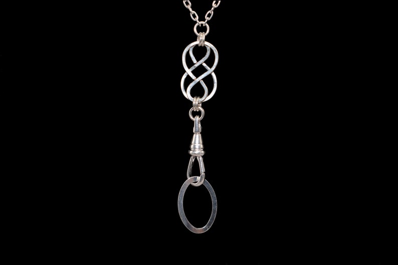 May include: Silver chain with a silver infinity knot pendant and a silver swivel clasp.