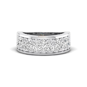May include: A wide, silver-toned ring with two rows of sparkling, clear gemstones. The ring has a rounded, curved design, and the gemstones are closely set, creating a brilliant, eye-catching effect. The ring is set against a white background.