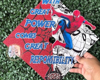 May include: Red and white graduation cap with a Spiderman graphic and the text "With great power comes great responsibility" and "2025".