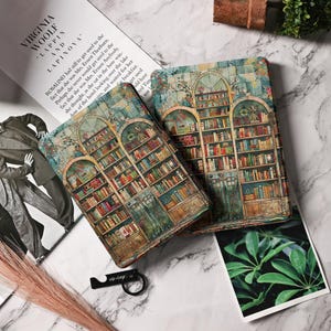 May include: Two decorative book covers with a vintage design featuring a bookshelf filled with books. The covers are made of a textured material with a blue, green, and brown colour scheme.