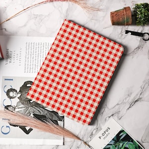 May include: A tablet case with a red and white gingham pattern. The case is made from a durable material and is designed to protect your tablet from scratches and bumps.