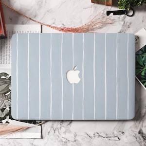 May include: A pale blue laptop case featuring a pattern of white vertical stripes. The case has a cut-out for the Apple logo. The rectangular case is displayed on a marble surface.
