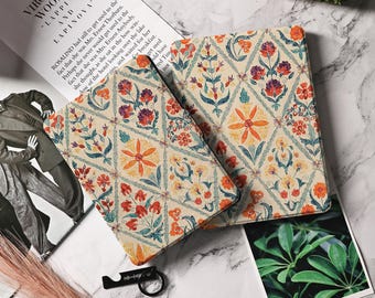 May include: Two book covers with a floral pattern in shades of red, orange, yellow, green, and blue on a white background. The pattern is a repeating geometric design with a diamond shape.