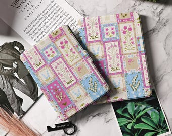 May include: Two floral patterned Kindle covers. The covers are made of a soft, durable material and feature a patchwork design with pink, blue, and white flowers. The covers are designed to protect your Kindle from scratches and bumps.