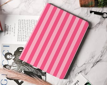 May include: A pink and light pink striped tablet case. The case is rectangular with rounded corners. The stripes are vertical and evenly spaced. The case is on a marble surface.
