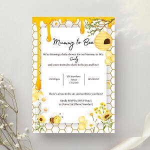 May include: A yellow and white baby shower invitation with a honeycomb pattern and a bee illustration. The text reads "Mummy to Bee" and includes the name "Emily".