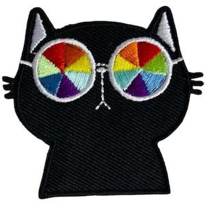 Könnte beinhalten: Gestickter schwarzer Katzenaufnäher mit weißen Akzenten an Ohren und Brillenrahmen. Die Sonnenbrille der Katze hat ein Regenbogenmuster. Geeignet für Jacken, Taschen oder andere Stoffartikel.