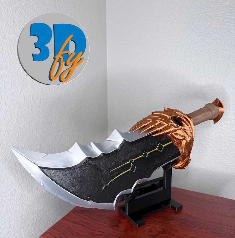 May include: A large, decorative sword with a silver blade and a black handle. The sword features gold accents and is displayed on a black stand. The text "3D by" is visible in a circular logo in the upper left corner.