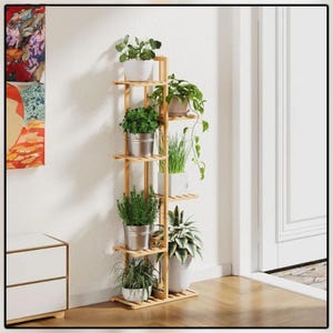 May include: A tall, multi-tiered bamboo plant stand filled with various potted plants. The stand has six shelves holding plants in white, silver, and terracotta pots. The plants include leafy green foliage and trailing vines, creating a natural, decorative display.