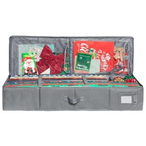 May include: A gray Christmas wrapping paper storage container, open to reveal various holiday supplies. Inside are rolls of wrapping paper, gift bags, bows, scissors, and gift tags. The container has a handle and a label holder.