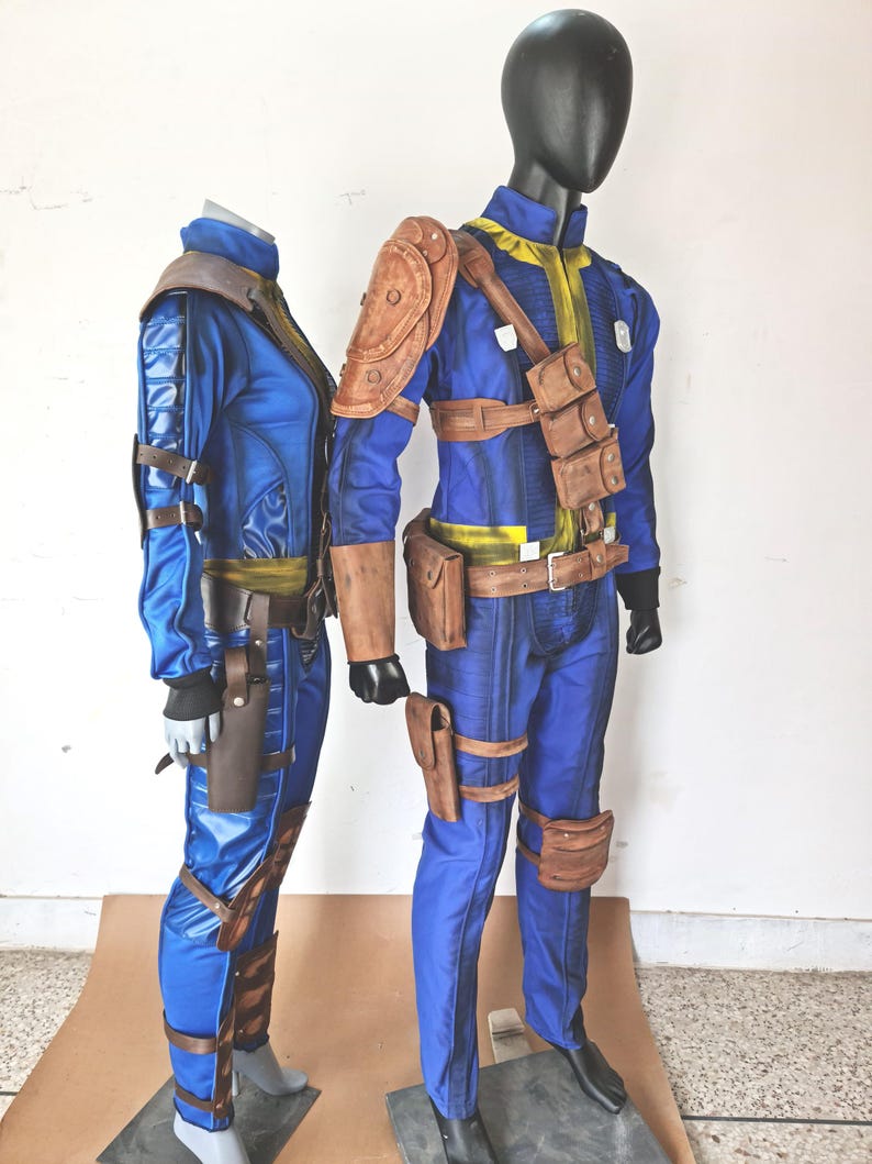 May include: Two blue and brown cosplay costumes with leather straps and pouches. The costumes are on mannequins.