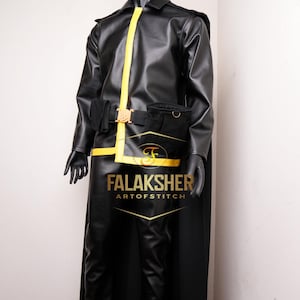 May include: Black leather costume with a yellow stripe down the front. The costume includes a jacket, pants, and a belt with a gold buckle. The text "FalakSher Art of Stitch" is printed on the front.