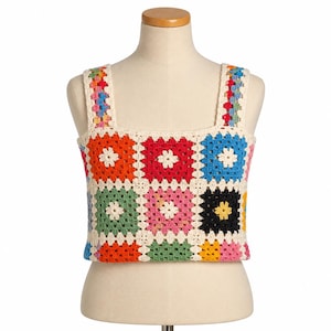 May include: A sleeveless crop top constructed from multi-coloured crochet granny squares. The garment features a square neckline and wide shoulder straps, with each square showcasing a central white flower motif surrounded by vibrant hues of red, blue, green, pink, yellow, and black, all joined by cream-coloured yarn.