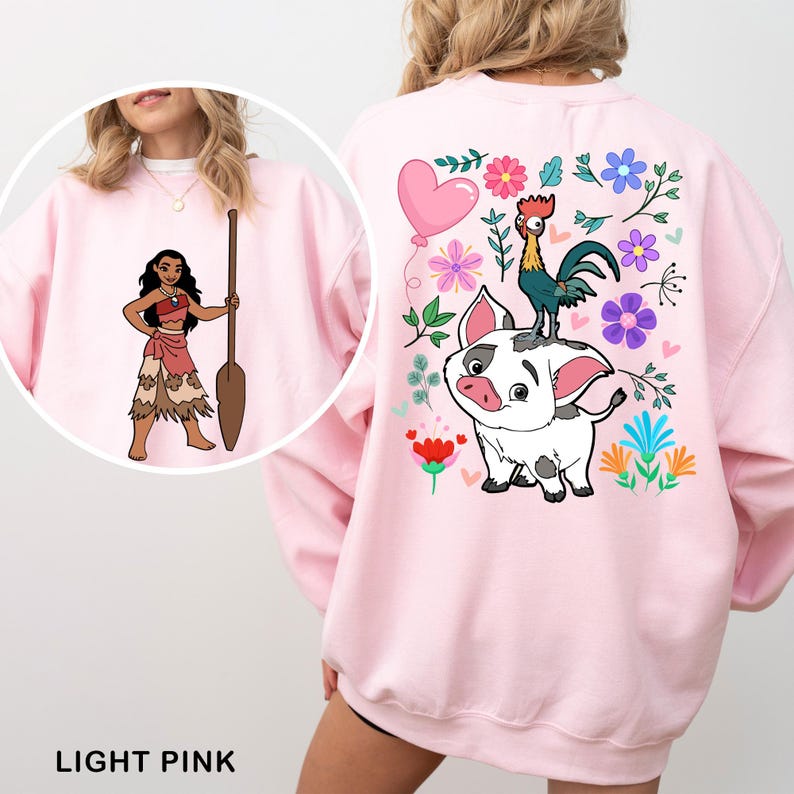 a woman wearing a pink sweatshirt with a cartoon character on it