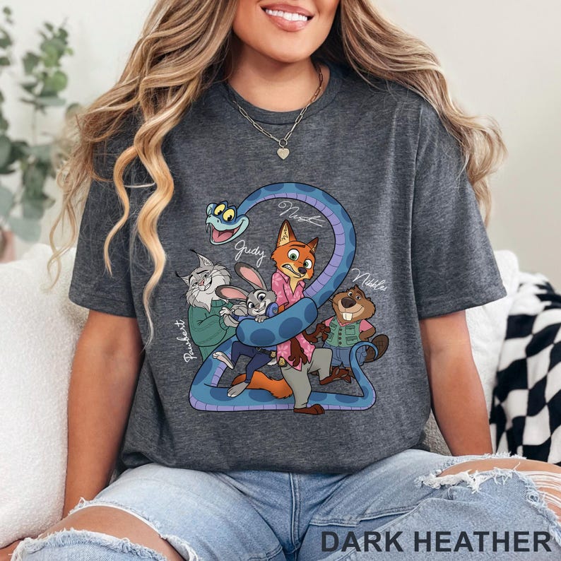 May include: Dark heather gray t-shirt featuring a cartoon illustration of characters from a movie. The design includes a blue snake, a fox, a rabbit, a beaver, and a cat. The text "DARK HEATHER" is at the bottom.
