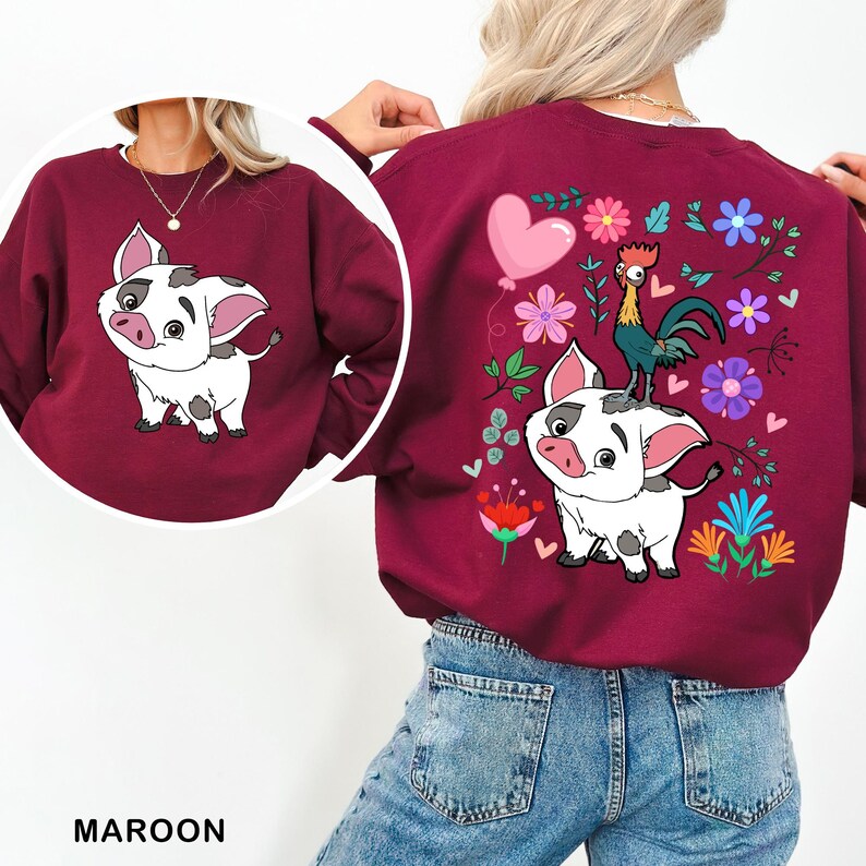 a woman wearing a maroon sweatshirt with a picture of a dog on it