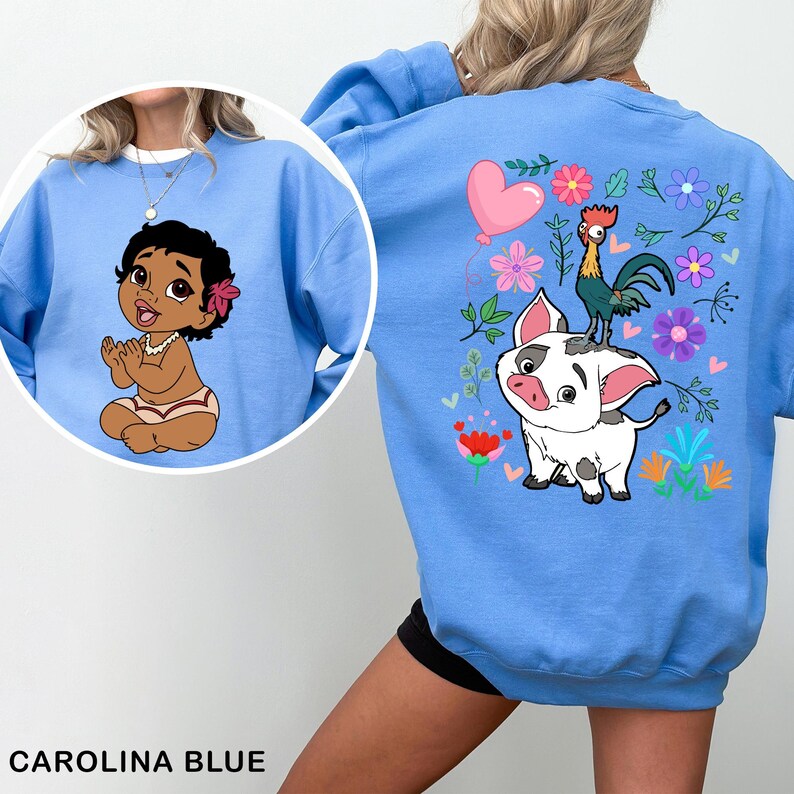 a woman wearing a blue sweatshirt with a cartoon character on it
