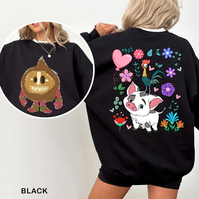 a woman wearing a black sweatshirt with a picture of a pig on it