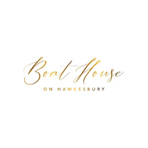 May include: Gold script logo for Boat House on Hawkesbury. The logo features a cursive font with a flowing design.