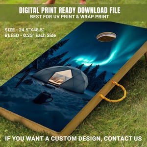 May include: A wooden cornhole board with a printed design of a dome tent in a snowy forest under a night sky with green and blue aurora borealis. The board is 24.5 inches by 48.5 inches.