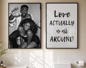 May include: Two framed wall art prints displayed in a bathroom. The left print is a black and white photograph of a couple in a bathroom. The right print features the black text Love ACTUALLY is all AROUND on a white background.