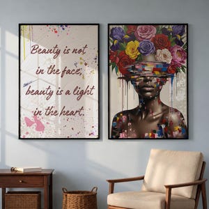 May include: Two framed art prints. One has the text "Beauty is not in the face, beauty is a light in the heart" with paint splatters. The other shows a woman with a floral headpiece and colourful paint details.
