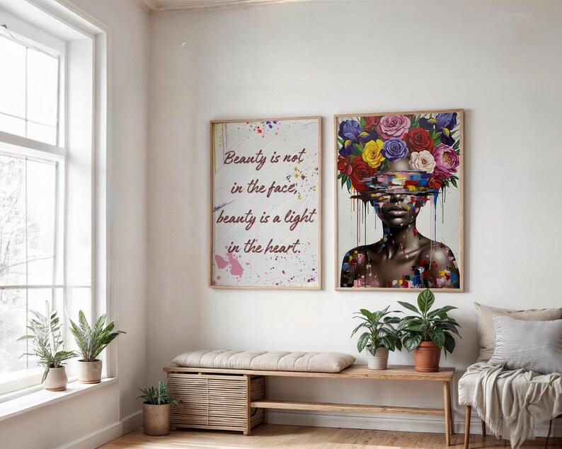 May include: Two framed art prints on a white wall. One has the text "Beauty is not in the face, beauty is a light in the heart." The other shows a woman with a floral headpiece. A wooden bench and potted plants are below.