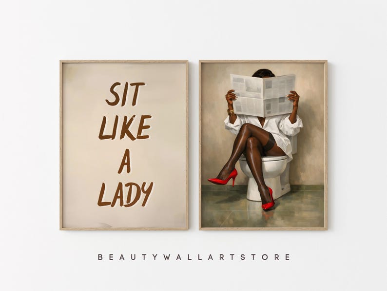 May include: Two framed art prints. One features the text "SIT LIKE A LADY" in brown lettering on a beige background. The other depicts a person in a white shirt, black stockings, and red heels, reading a newspaper while seated on a toilet.