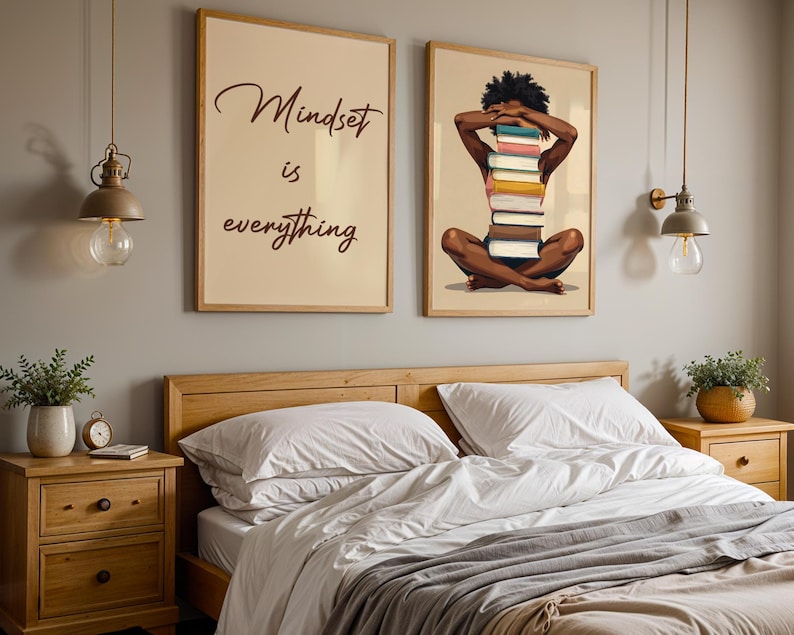 May include: Two framed art prints hang above a bed. One print reads "Mindset is everything" in script. The other depicts a person with a stack of books. The bedroom has wooden furniture and pendant lights.