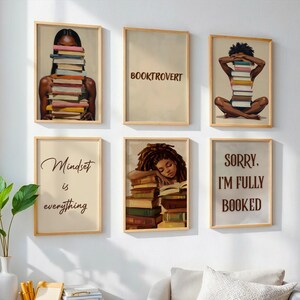 May include: Six framed art prints with a literary theme. The prints feature illustrations of people with stacks of books, and text that reads "Booktrovert", "Mindset is everything", and "Sorry, I'm fully booked".