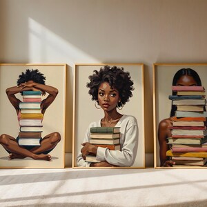 May include: Three framed art prints featuring illustrations of Black women with stacks of books. One woman sits cross-legged with a book stack covering her face. Another holds a stack, and the third has books in front of her face.