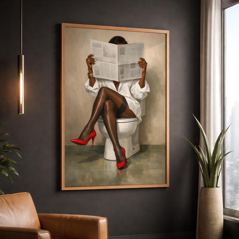 May include: A framed artwork depicts a person seated on a toilet, reading a newspaper. The person wears a white shirt, black stockings, and red high heels. The artwork is in a room with a neutral color palette.