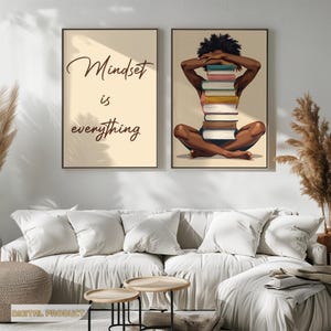May include: Two framed art prints. One reads "Mindset is everything" in elegant script. The other depicts a person with dark skin, seated cross-legged, holding a stack of books. The art has a neutral color palette.
