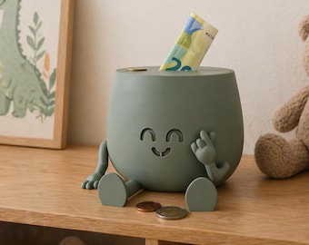 Hucha alegre con carita sonriente que simboliza el pago: un regalo único disponible en varios colores y tamaños.