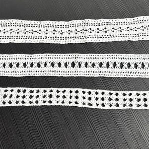 May include: Three white crochet lace strips featuring distinct openwork patterns. Each strip displays a unique geometric design created with fine thread, showcasing intricate needlework and delicate textures in a long, narrow rectangular shape.